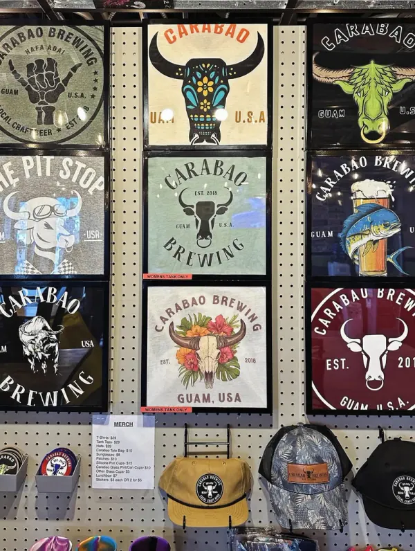 The merch wall of Carabao and Pit Stop shirts and hats